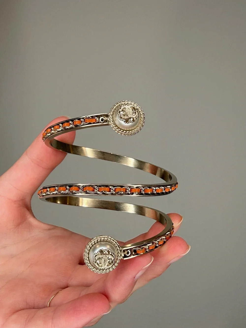 CHANEL Cruise 2018 Gold-Tone Spiral Cuff Bracelet with Orange Leather Accents